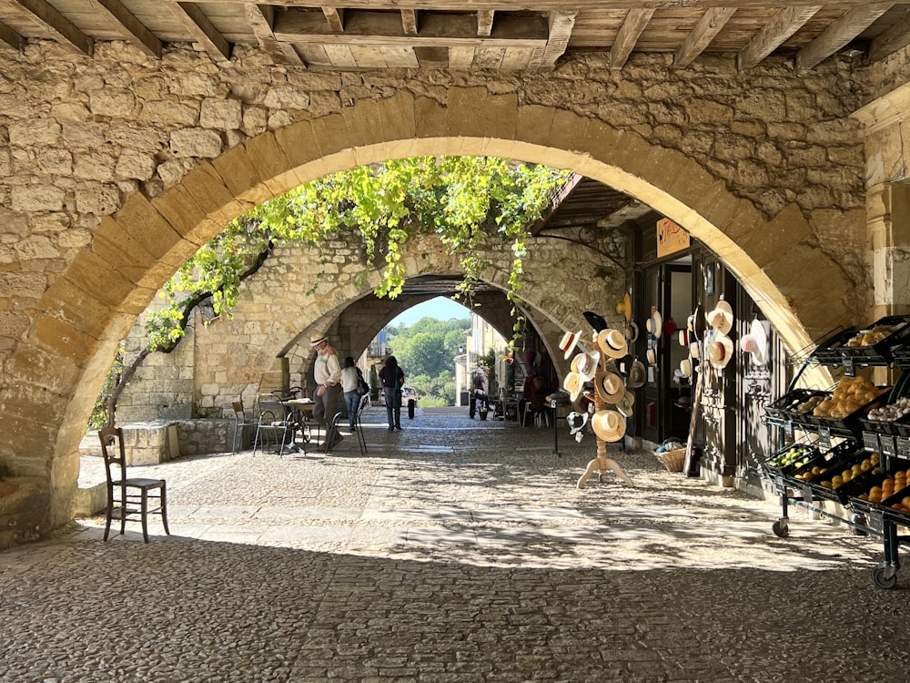 a cobblestone street with a stone archway