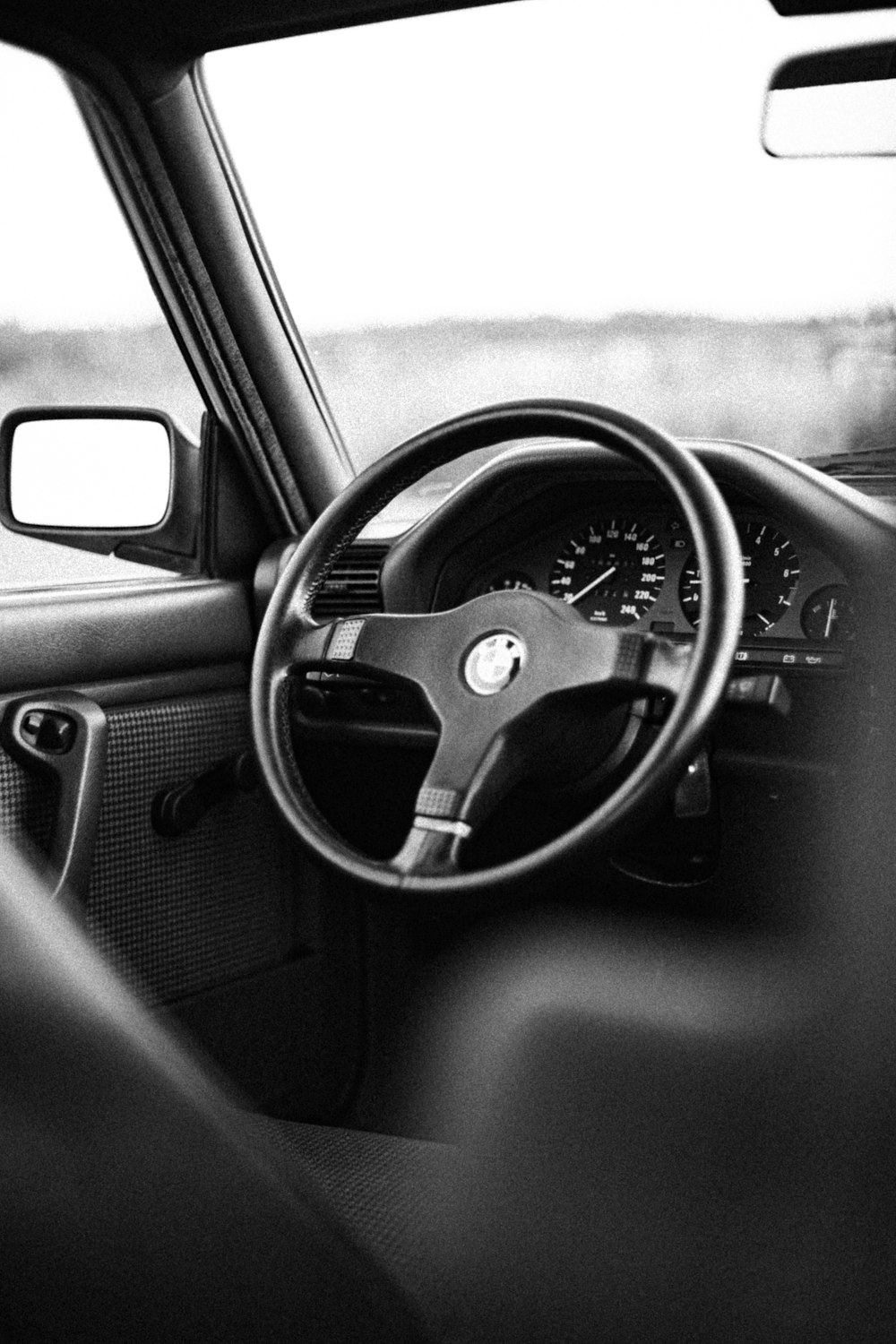 a black and white photo of a car dashboard