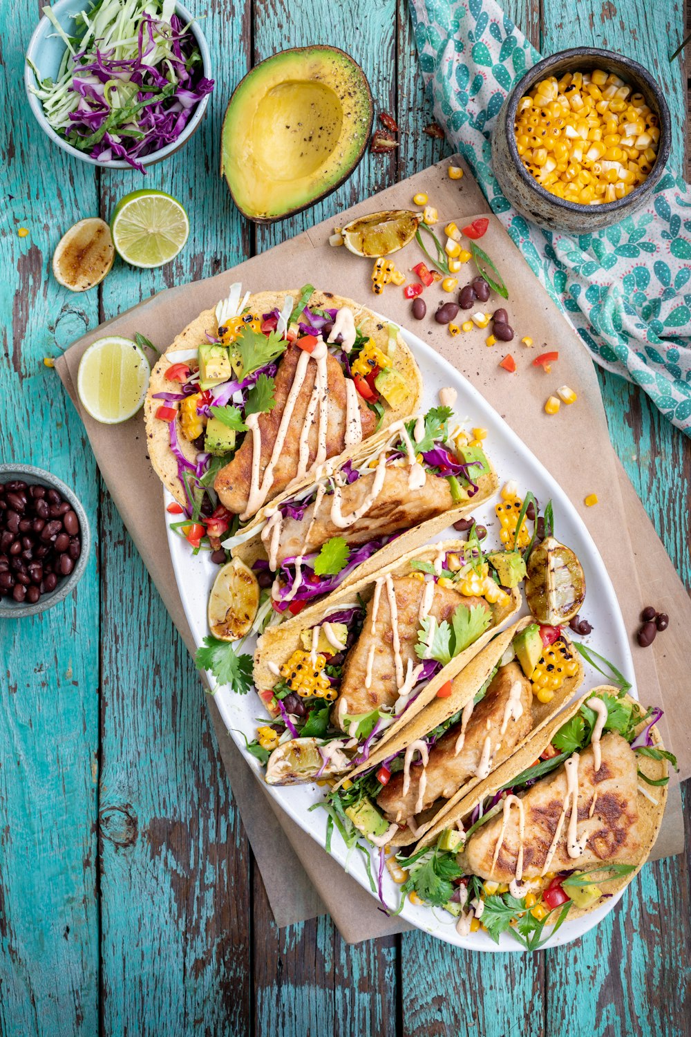 a white plate topped with tacos covered in toppings