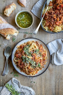 a plate of spaghetti with sauce and bread