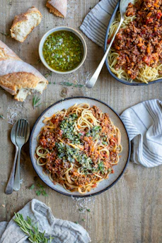 a plate of spaghetti with sauce and bread