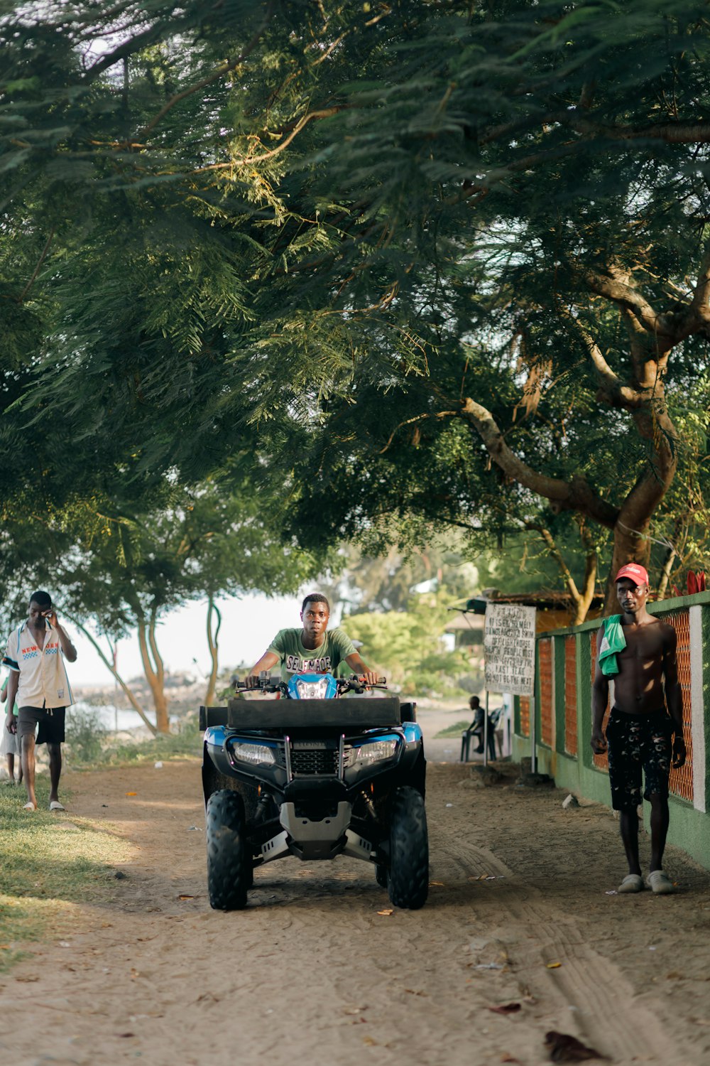 a man riding on the back of a four wheeler