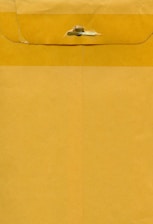 A large brown envelope with a metal clasp closure at the top. The envelope appears to be made of kraft paper with visible creases and texture.