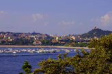 Scenic view of São José da Barra’s waterfront with lush greenery.