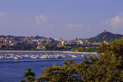 Scenic view of São José da Barra’s waterfront with lush greenery.