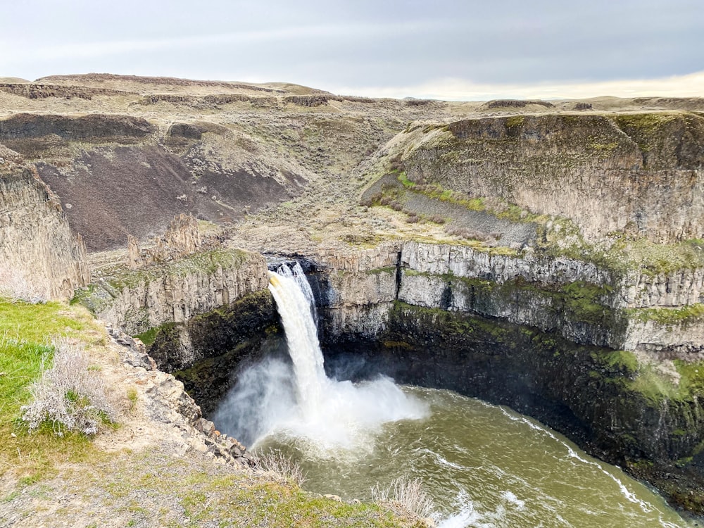 a large waterfall is coming out of the ground