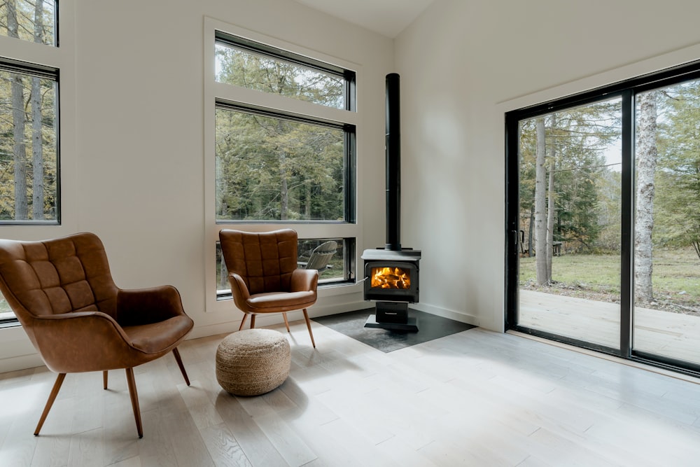 a living room with two chairs and a fire place