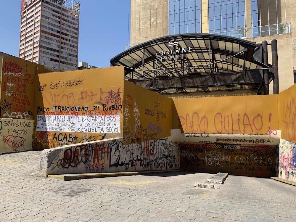 a bunch of graffiti on the side of a building