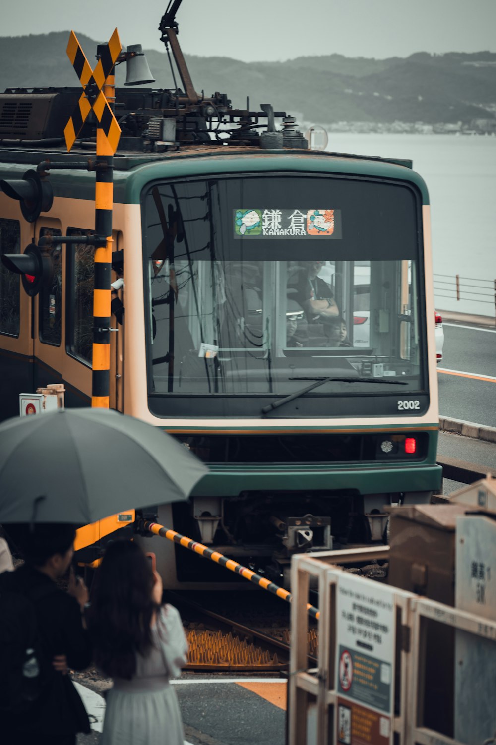 a group of people standing next to a train