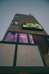 Modern condominium building with digital interface overlay showing automation features.