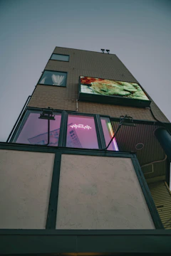 Modern condominium building with digital interface overlay showing automation features.