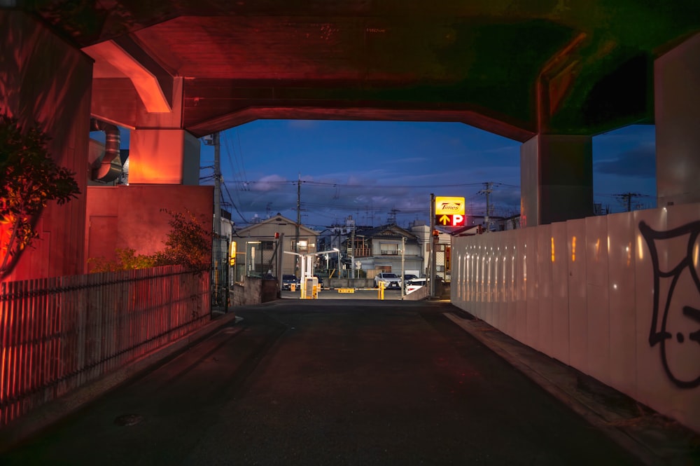 a street with a white fence and a red traffic light