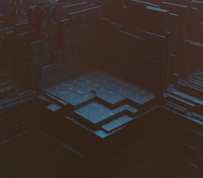 A dark, abstract digital landscape with layered, geometric structures resembling a futuristic, industrial complex. The scene gives a sense of depth and complexity, with varying levels of platforms and shadowy areas.