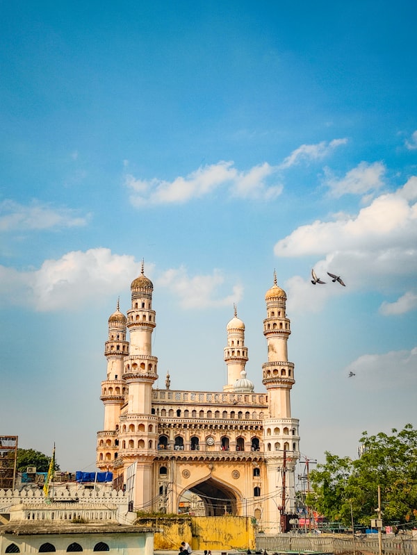 Charminar monument illuminated at night with bustling Laad Bazaar in Hyderabad