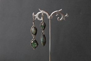 Elegant cream earrings with gemstone accents.