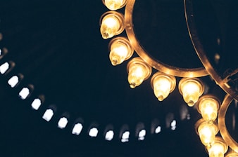 Close-up of bright LED lights and elegant chandeliers being installed
