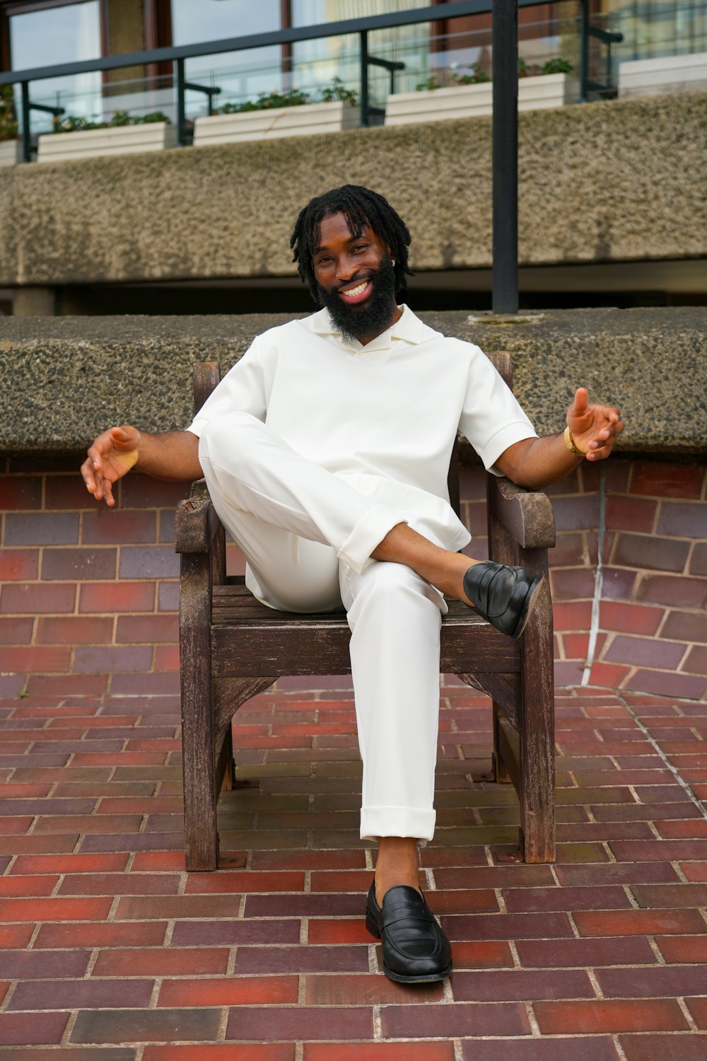 a man sitting in a chair with his legs crossed