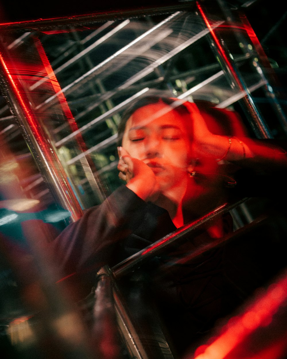 a woman sitting in a bus looking in the mirror