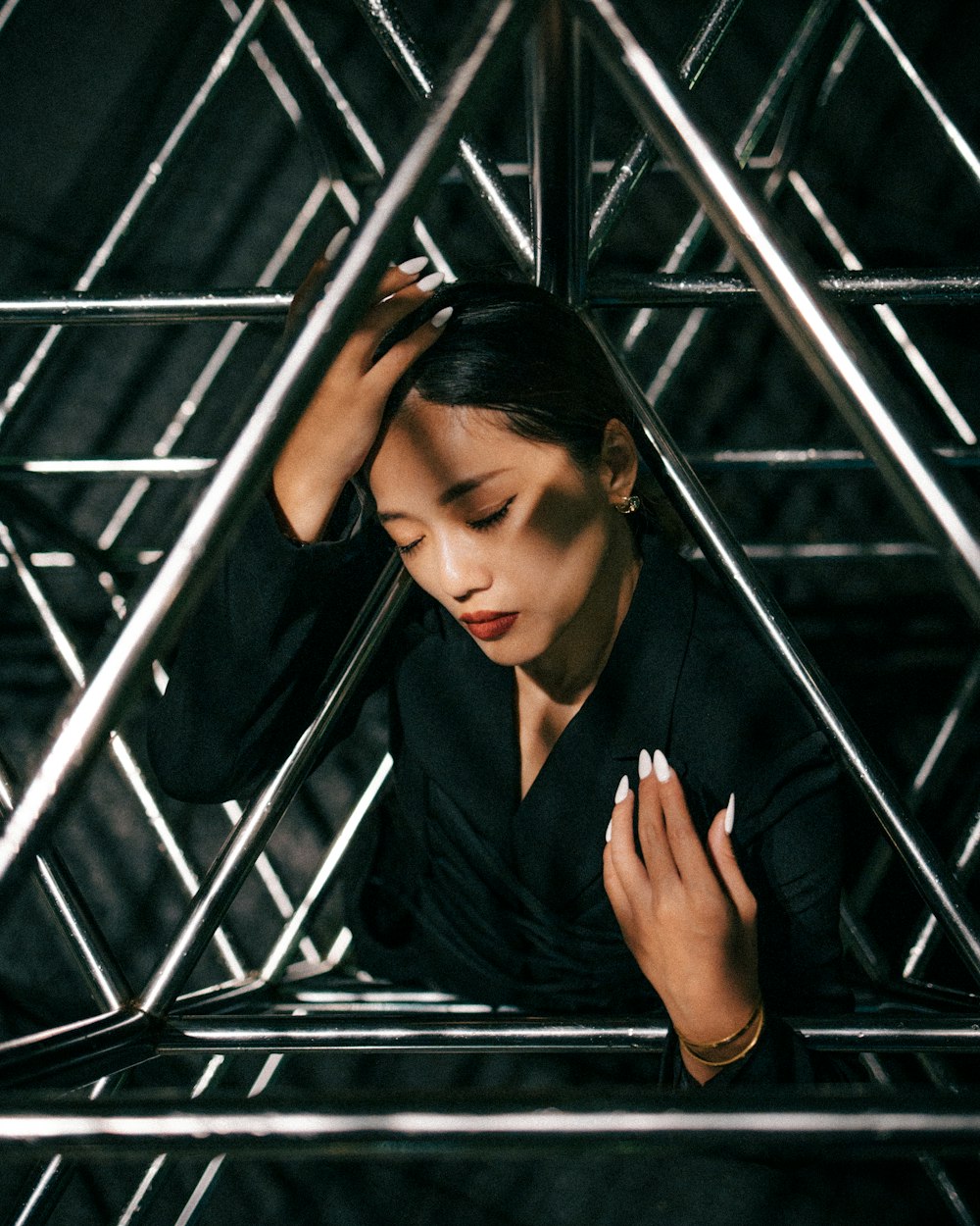 a woman standing in front of a metal structure