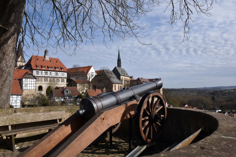 a large cannon sitting on top of a wooden bench