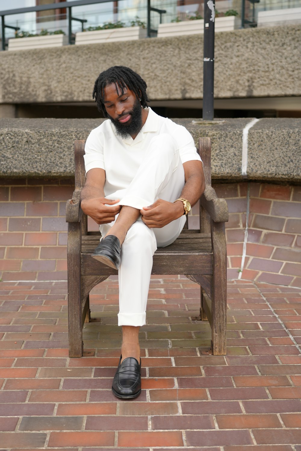 a man sitting in a chair with his legs crossed