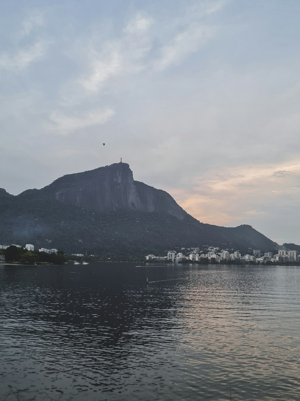 a body of water with a mountain in the background