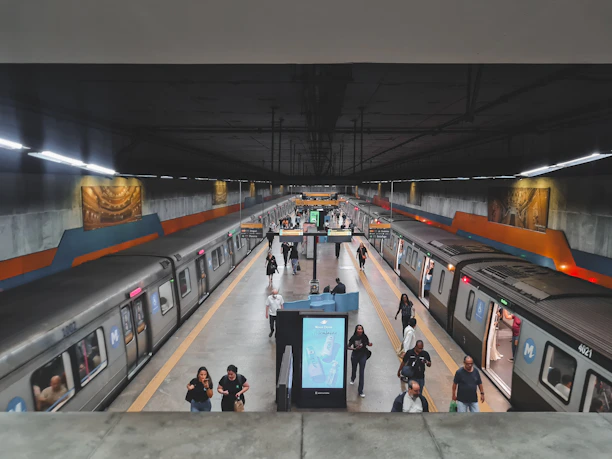 A bustling Seoul subway platform with sleek trains and commuters immersed in their journeys.