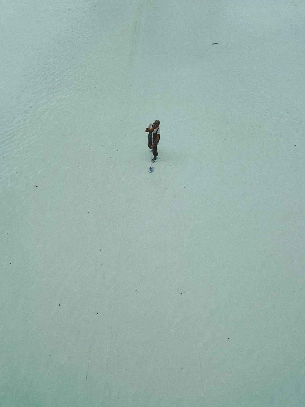 a person walking across a snow covered field