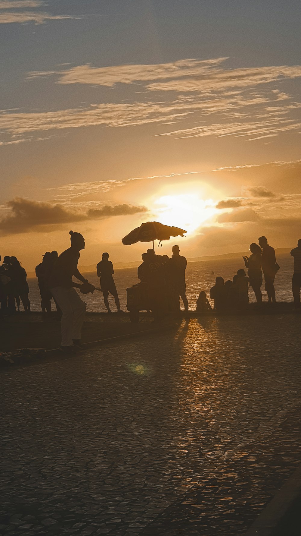 a group of people standing on top of a beach