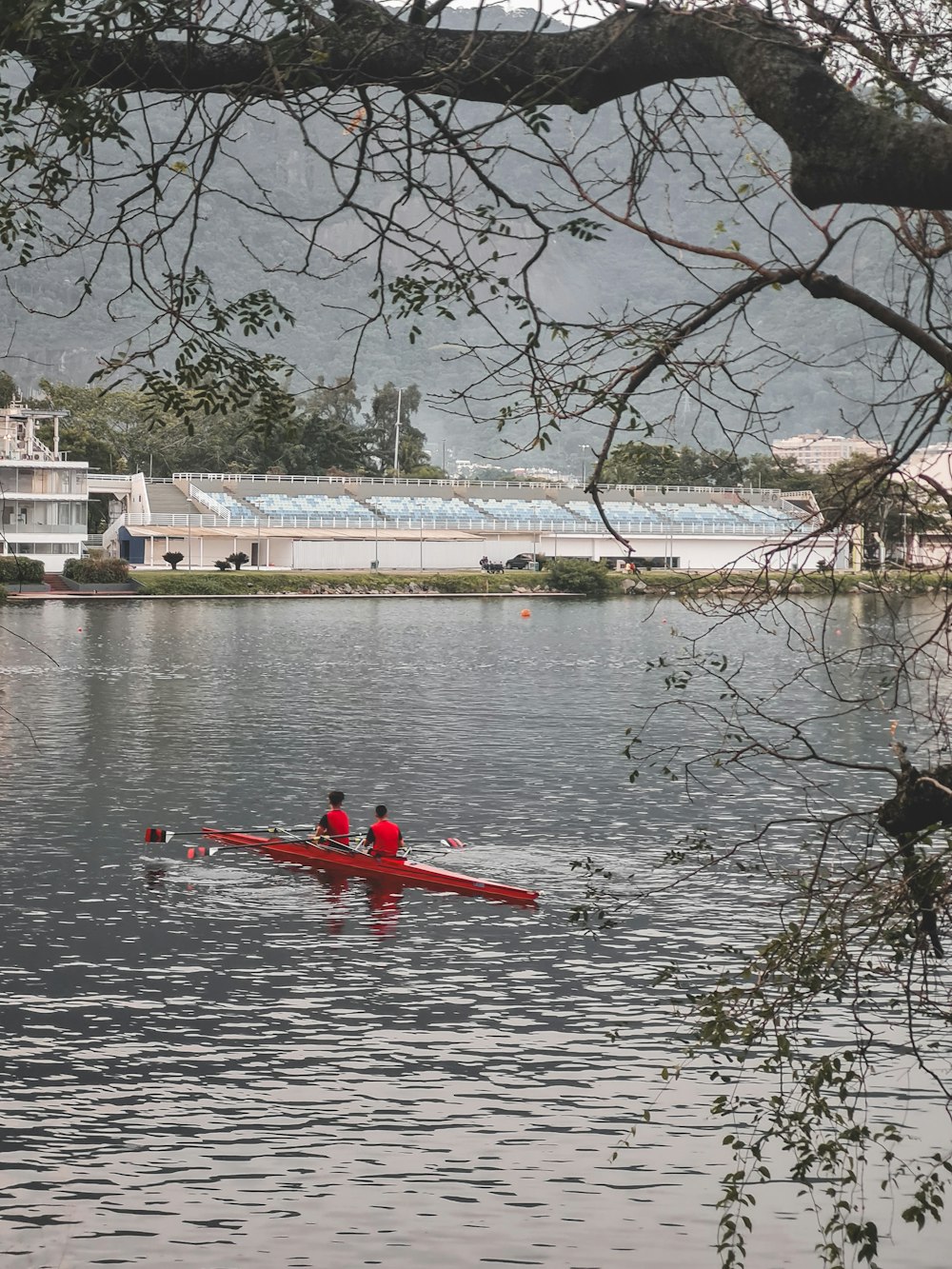 a couple of people in a red boat on a body of water