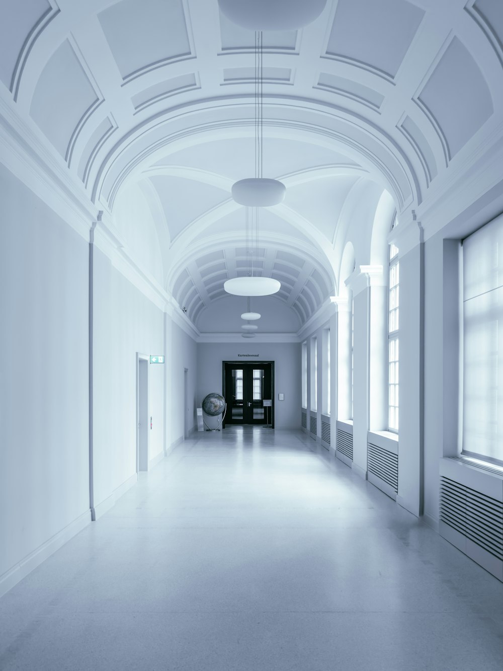 a long hallway with a clock on the wall