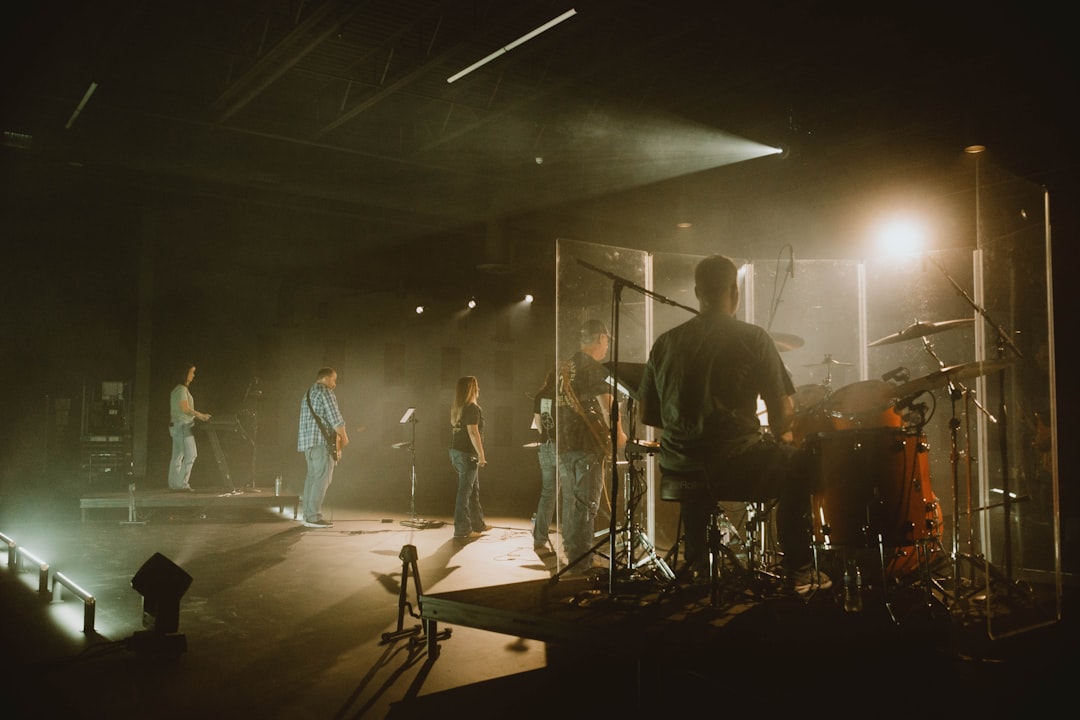 a group of people standing on top of a stage,