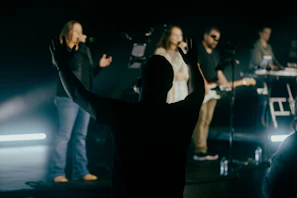 A colorful stage setup with musicians performing to an engaged audience
