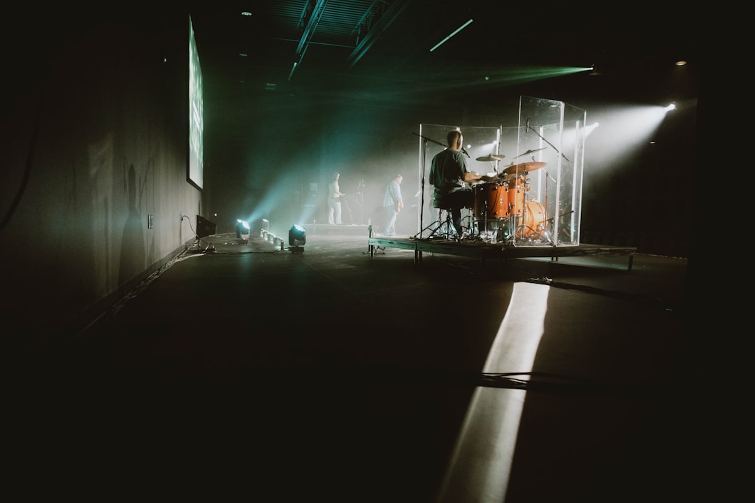 a group of people standing around a stage,