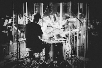 a man playing drums in front of a group of people
