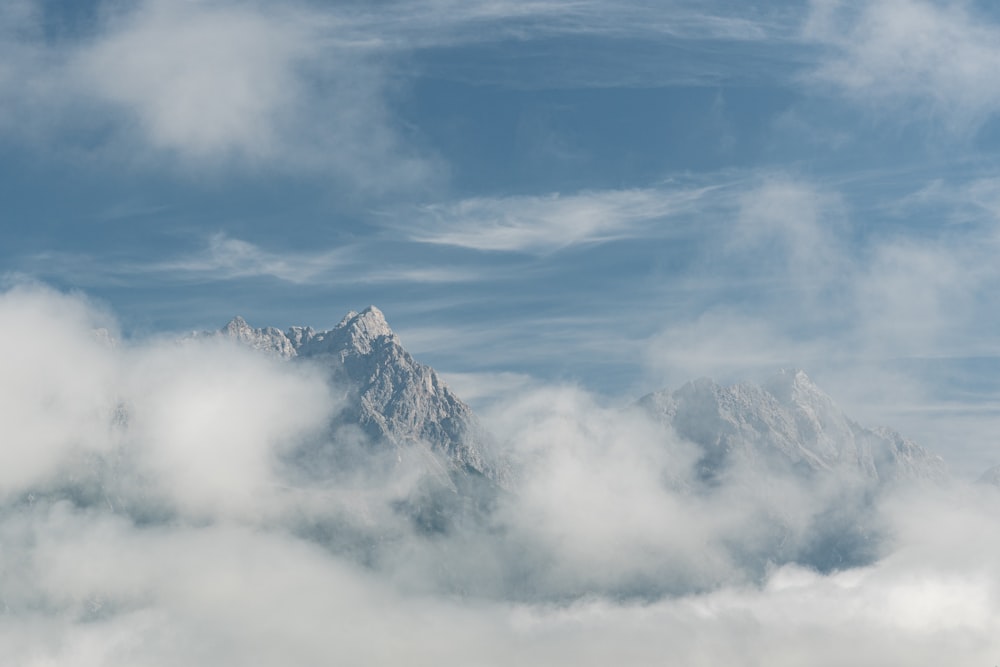 a view of the top of a mountain in the clouds