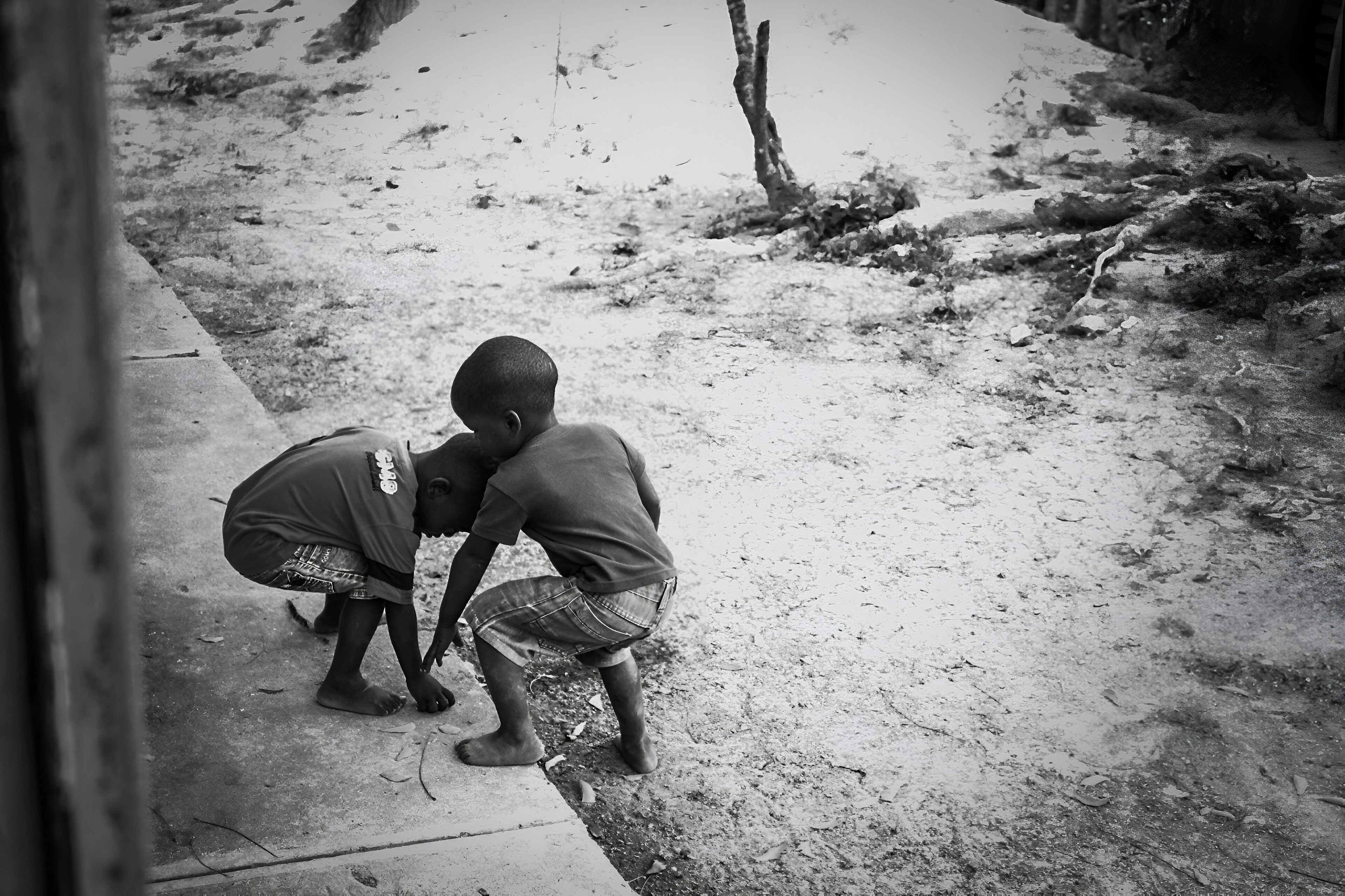 a couple of kids standing on top of a sidewalk