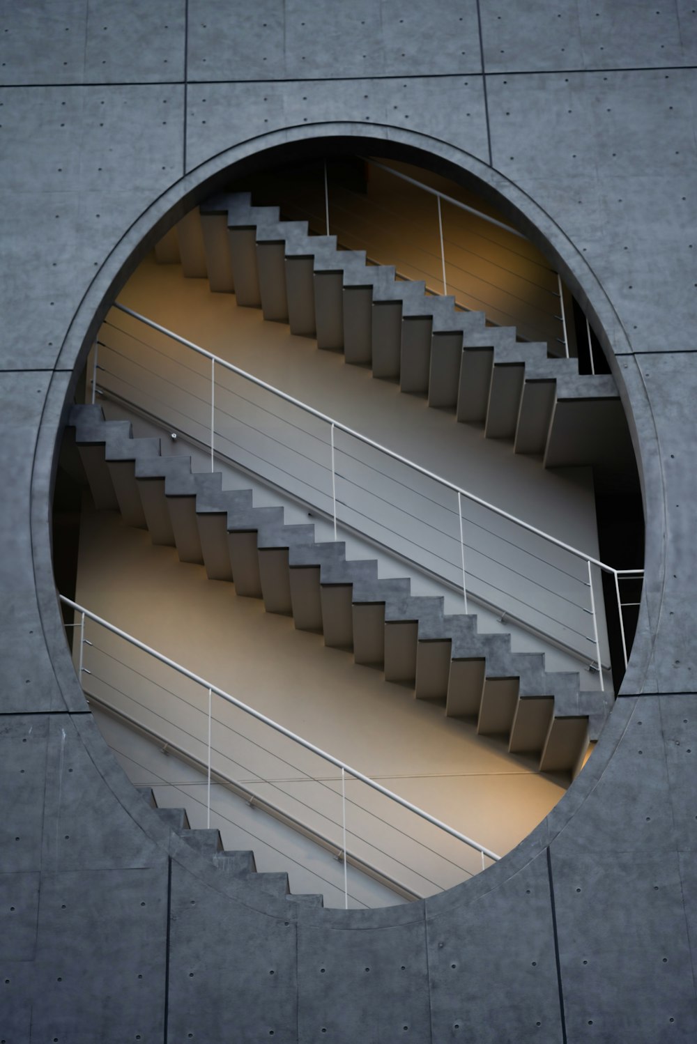 a circular window with a spiral staircase in it