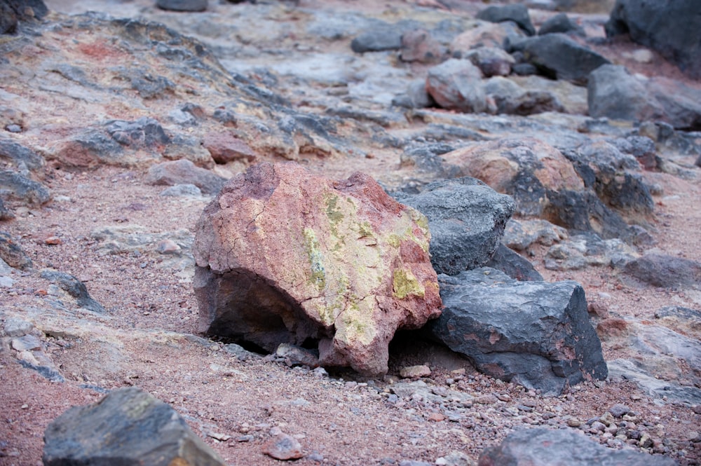 a large rock sitting on top of a rocky hillside