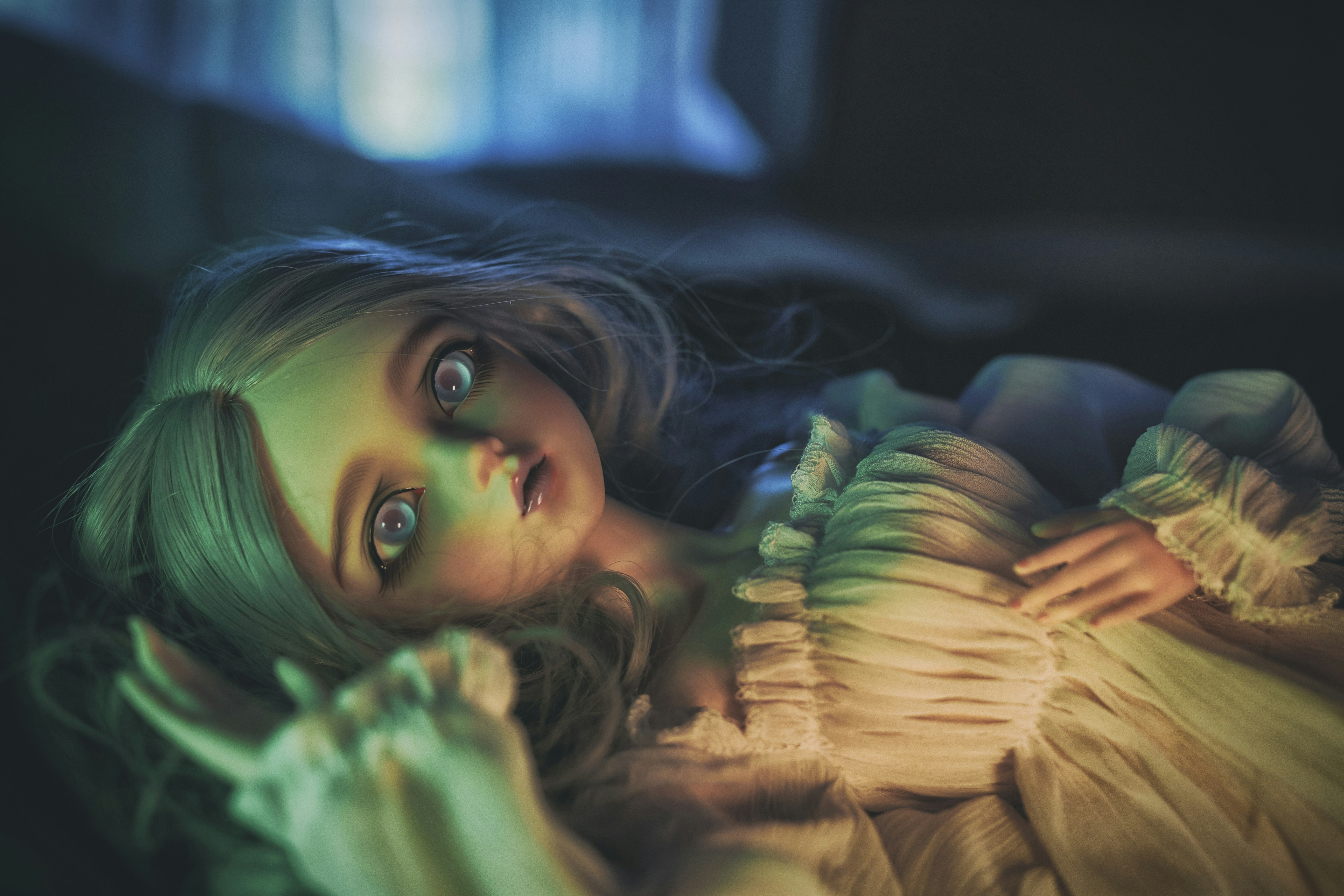 a woman in a yellow dress laying on a bed