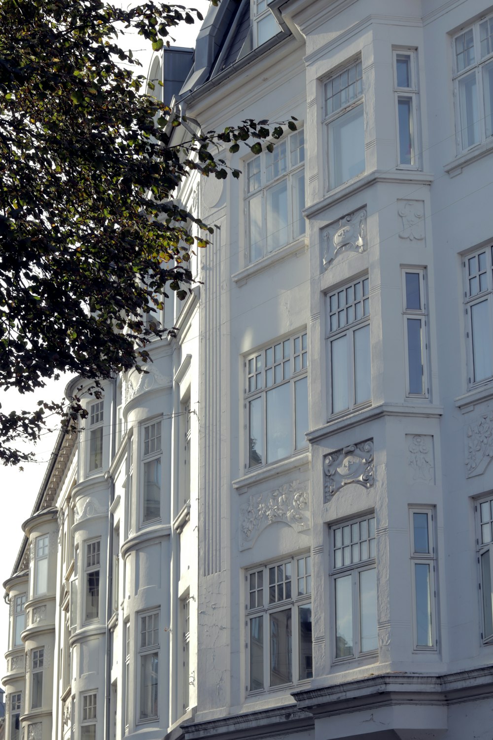 a large white building with a clock on the front of it