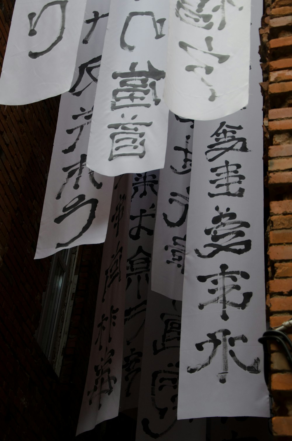 a bunch of signs hanging from the side of a building