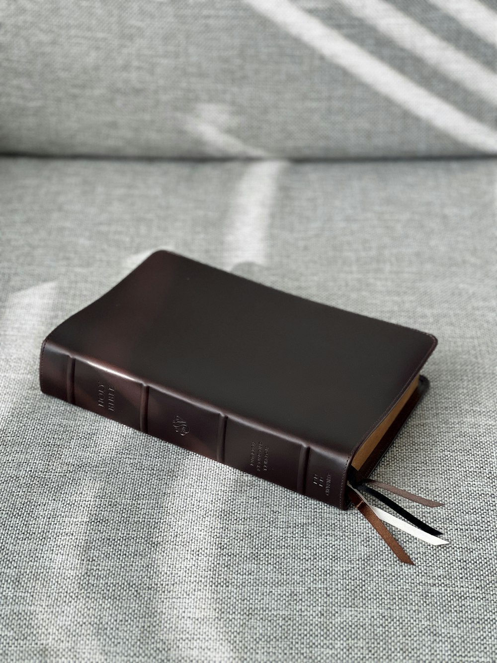 a leather book with a pair of scissors sticking out of it
