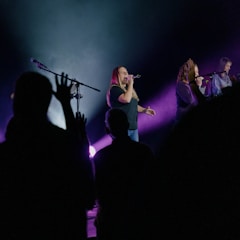 A group of singers performing together on stage.