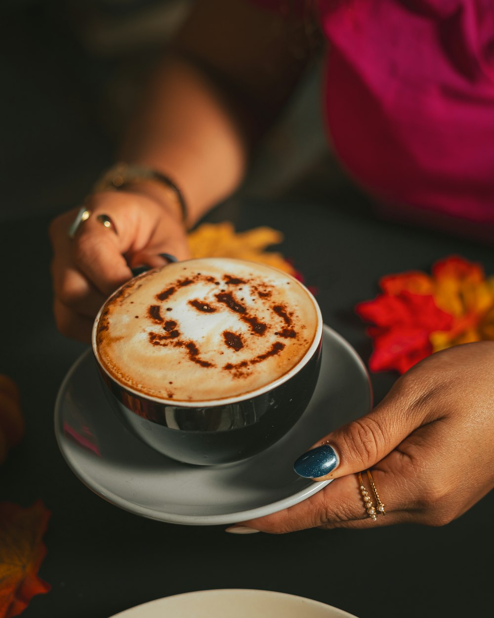 a cup of coffee with a smiley face drawn on it