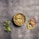 Close-up of a bowl of traditional dal curry garnished with fresh coriander leaves.