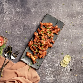 A vibrant shot of freshly prepared sides and dipping sauces complementing the fried chicken.