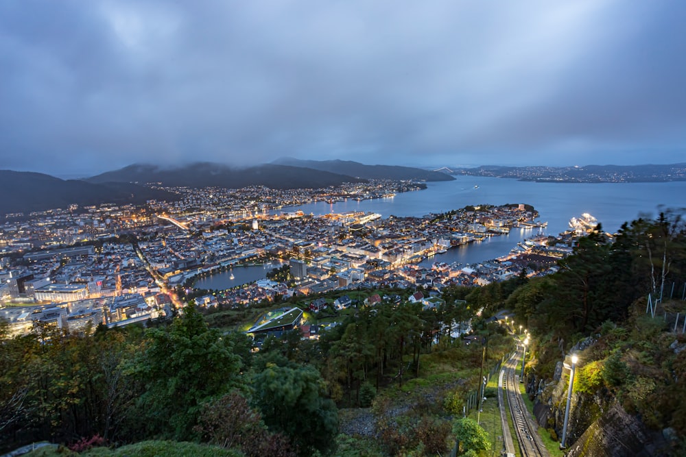 a view of a city at night from the top of a hill