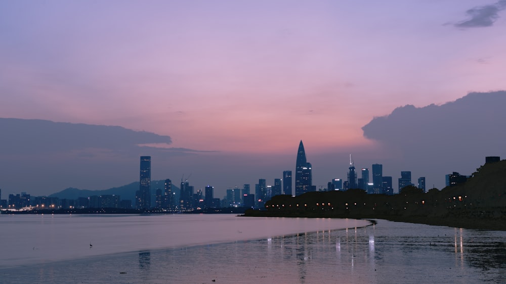 a large body of water with a city in the background