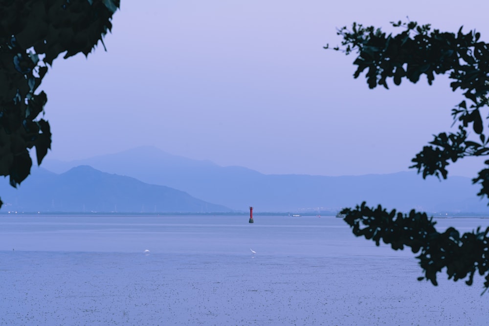 a body of water with mountains in the background